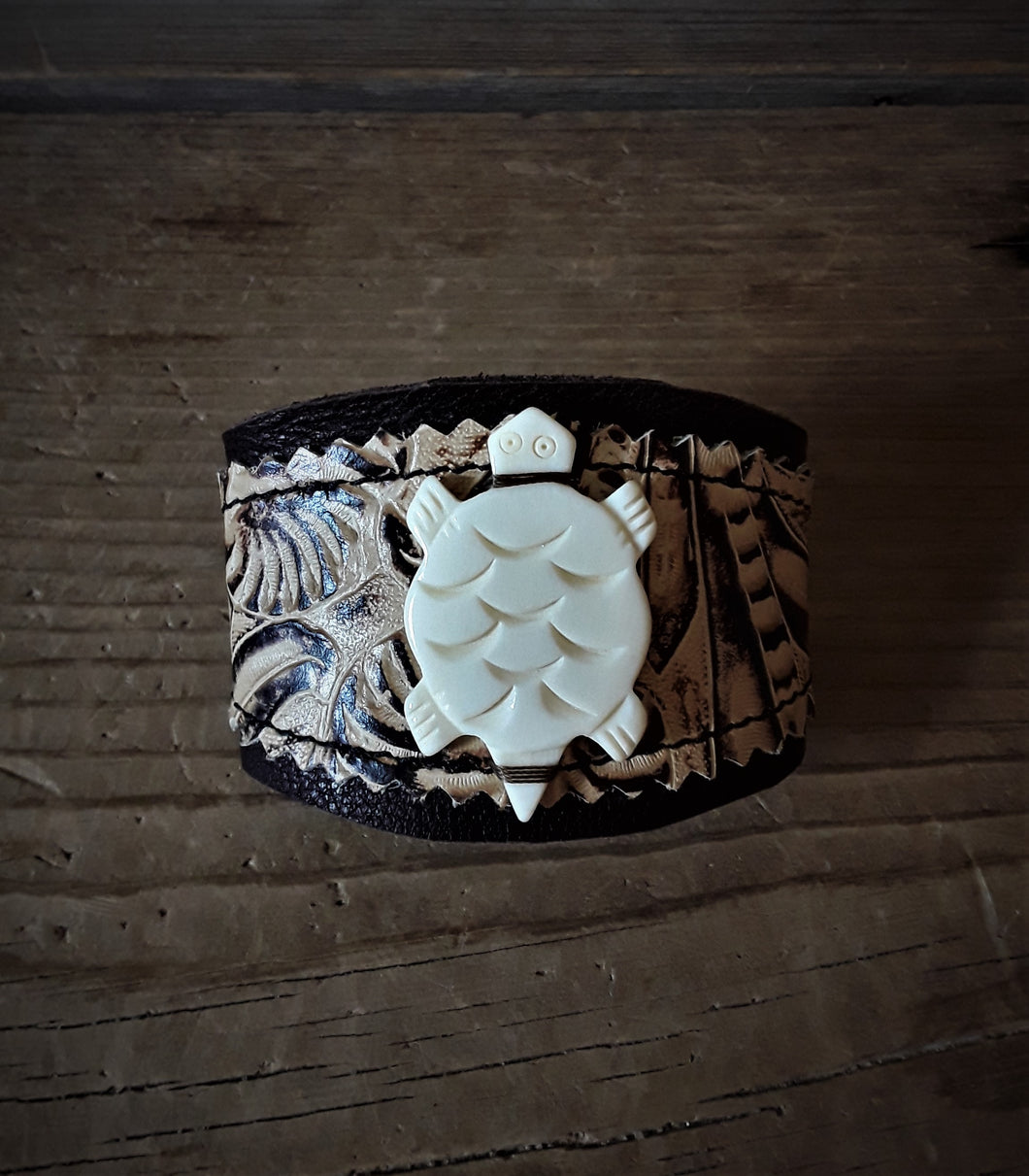 Two-Toned Fossil Embossed Leather Cuff Bracelet With Carved Turtle